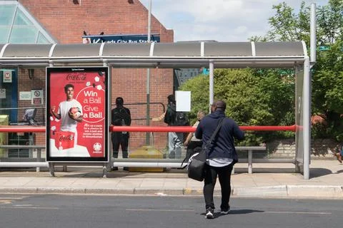 Coca Cola advertisement post on bus stop in the street Stock Photos