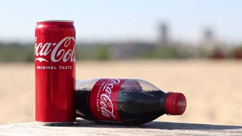 Coca-Cola can and bottle on wooden table on beach background Stock Footage 334246980