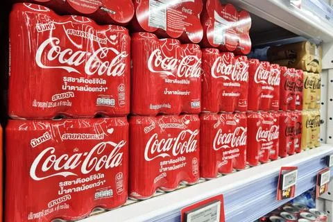 Coca Cola cans on shelf. Stock Photos