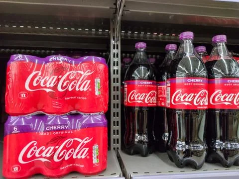 Coca Cola cherry bottles on display for sell at a supermarket shelf in France Stock Photos