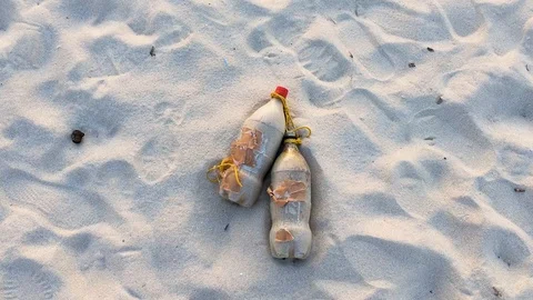 Coca Cola Coke Plastic Bottles Lying In The Sand. Environment Destruction. Video stock 102880306