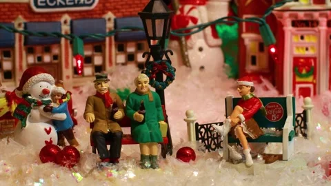 Coca Cola Holiday Vintage Village collection Seniors and child with snowman Stock Footage