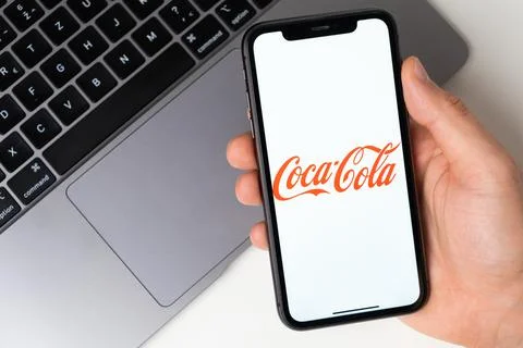 Coca Cola mobile application on the smartphone screen. Make purchases while Stock Photos
