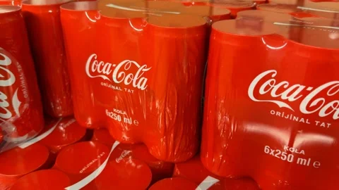 Coca-Cola packages on display with red branding and logo in a retail setting Stock Footage 330927554