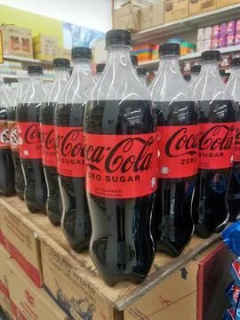 Coca-Cola Zero Sugar Bottles Displayed on Store Shelf in Bulk Stock Photos