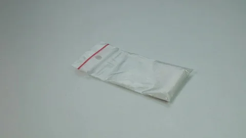 Cocaine and pills fall on the table Stock Footage 89325377