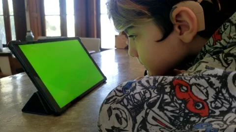 Cochlear implant boy usin tablet croma 1 Video stock 138849798