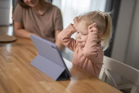 Cochlear implant system. Installation cochlear implant on child girl ear for Stock Photos