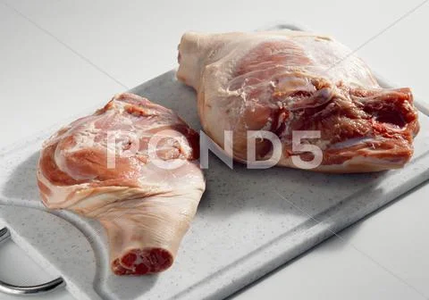 Cochon de lait (shoulder and leg) on a chopping board Stock Photos