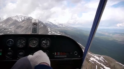 Cockpit control lever beneath us mountains Stock Footage 40546976