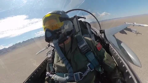 Cockpit footage of pilot flying F-16 fighter jet over desert Stock Footage 201861066
