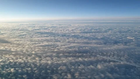 Cockpit perspective of airplane flying high above clouds with contrail 動画素材 276700302