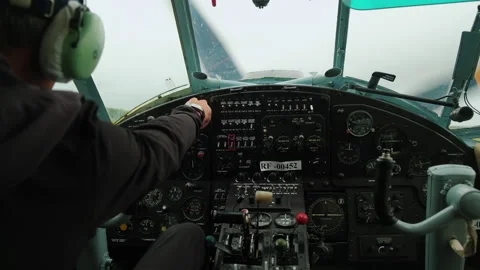 Cockpit of Small Plane. View from over Pilot's Shoulder. Man Starts Engine. Stock Footage 196202728