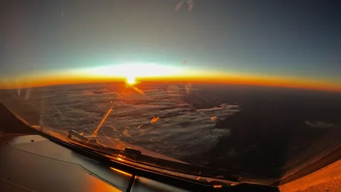 Cockpit Sunset Time-Lapse Above the Clouds During Cruise Flight Stock Footage 340420451