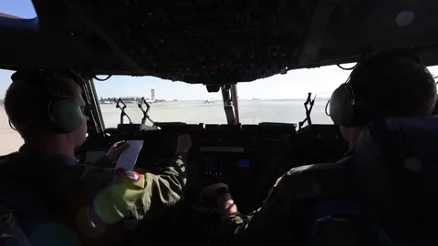 Cockpit view of co-pilot adjustring controls of C-17 Globemaster while taxiing Stock Footage 97444825