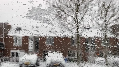 Cockpit view. Ice melts on the windshield of the car. Car wipers cleans Stock-Footage 148416083