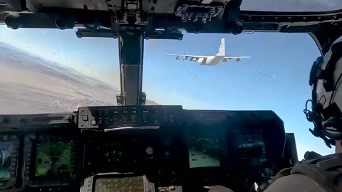 Cockpit view from MV-22 Osprey approaching KC-130 Hercules for air-to-air refuel Stock Footage 232393941