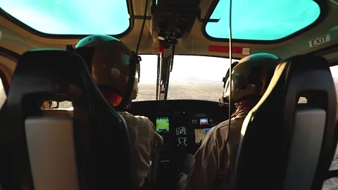 Cockpit view U.S Customs Border Protection pilot flying AS350 A-Star over desert Stock Footage 301077841