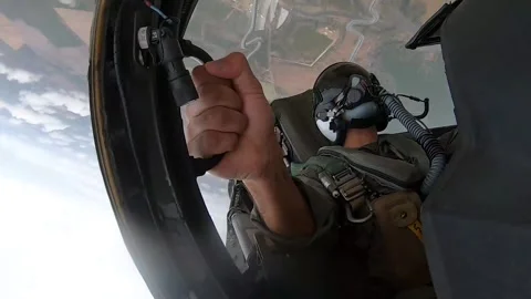 Cockpit view U.S Marines AV-8B Harrier II passenger holds on during aileron roll Stock Footage 263112137