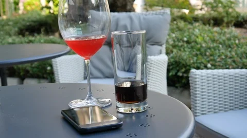 Cocktail and cell phone on the table Stock Footage 90290910