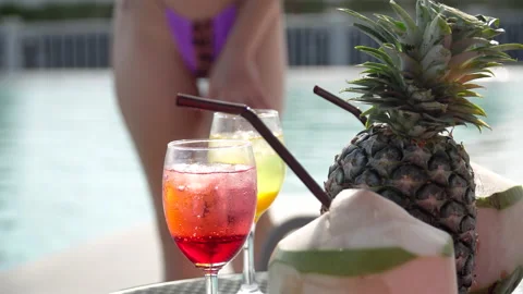 Cocktail and fruit pineapple , coconut on table over blur of sexy woman in bi Stock Footage 146316914