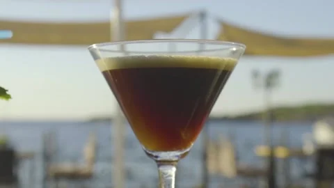 Cocktail on a bar with sun setting in the background Stock Footage 140051235