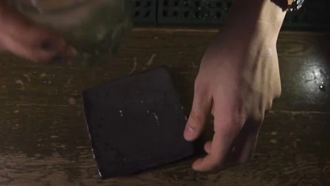 Cocktail being placed on table Stock Footage 90123086