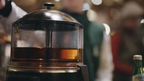 Cocktail drink is mixed in transparent container mixer at Christmas market st Stock Footage 345756489