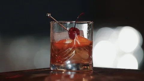 Cocktail is fully ready. The bartender brings a beautifully designed drink to Stock Footage 129111064