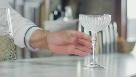 Cocktail glass held by a bartender Stock Footage 323049727