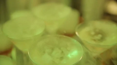 Cocktail in glass with splashes and lemon on dark smoky background. Party club Stock Footage 87677684