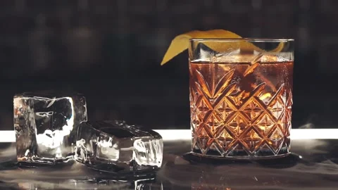 Cocktail with ice cubes on the bar Stock Footage 119365776