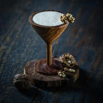 Cocktail martini in wooden glass on wooden background. Stock Photos