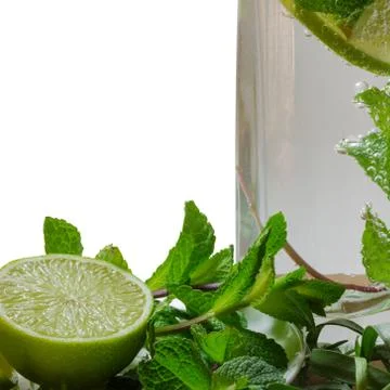 Cocktail mojito with a slice of lime, mint and estragon Stock Photos