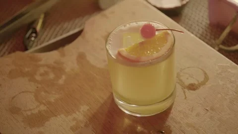 Cocktail with Orange Slice and Cherry Garnish on Bar Counter in Beijing, China Stock Footage 345754679