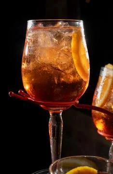 Cocktail with Orange Slice in Glass, Dramatic Lighting on Dark Background. Stock Photos