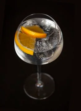 Cocktail with orange slices and ice cubes in an elegant Hugh stem glass Stock Photos