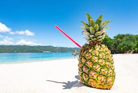 Cocktail in pineapple on the sand 写真素材