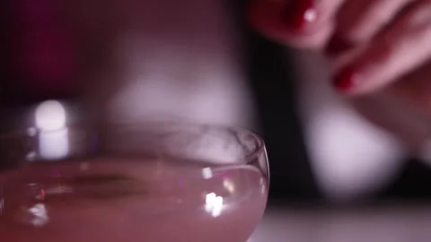 Cocktail preparation close-up. The bartender puts lime in cocktail. Selective Stock Footage 263095525