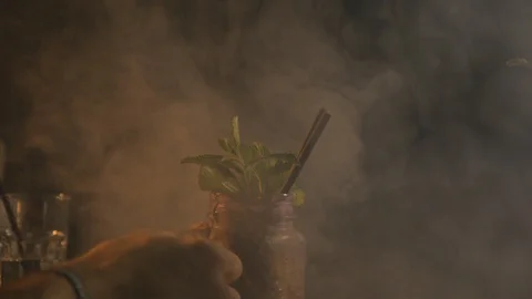 Cocktail preparation slow motion, smoky warm atmosphere Stock Footage 91498341