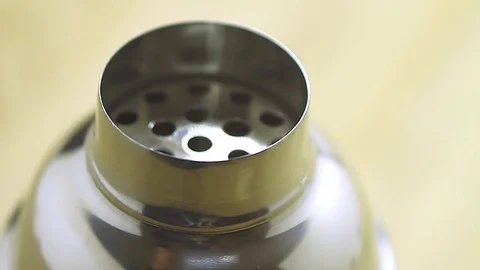 Cocktail shaker rotates on a plate Stock Footage 74845293