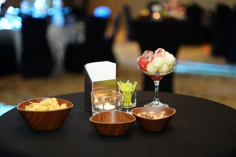 Cocktail snacks on bistro table Stock Photos
