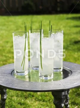 Cocktails With Blades Of Grass On Table Out Of Doors