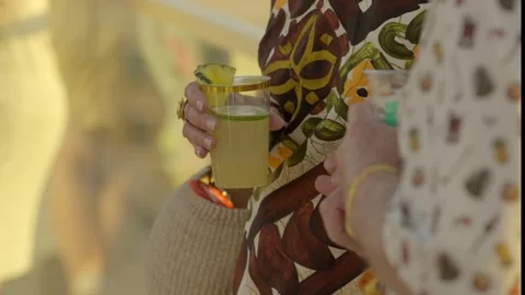 Cocktails held close up sunset back Stock Footage 308205616