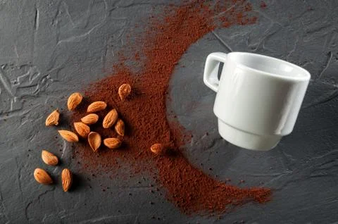 Cocoa beans with a cup on a dark gray background. Top view 写真素材