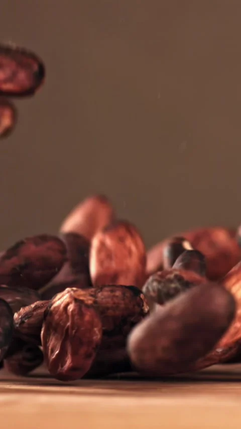 Cocoa beans fall on the table. Filmed on a high-speed camera at 1000 fps Stock Footage 335374259