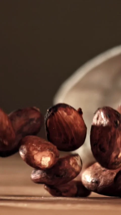 Cocoa beans fall on the table. Filmed on a high-speed camera at 1000 fps Stock Footage 335375546