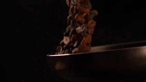 Cocoa beans tossing and roasting in pan cooking food slow motion Stock Footage 102618632
