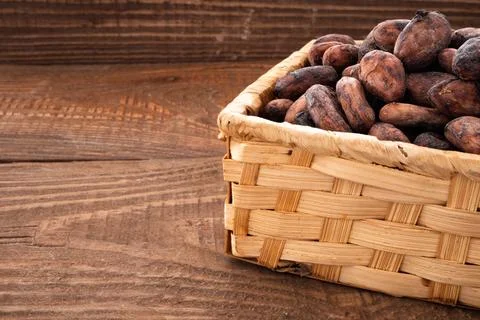 Cocoa beans in a wicker box Stock Photos
