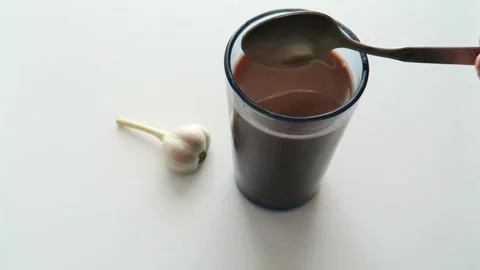 Cocoa drink in a glass stirred with a spoon. Stock Footage